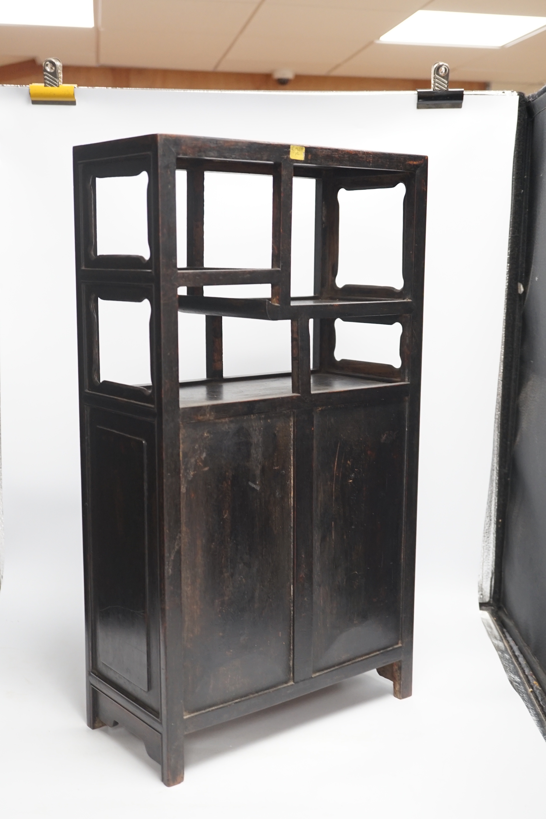 An early 20th century Chinese hongmu cabinet with carved cupboard doors, 61cm high